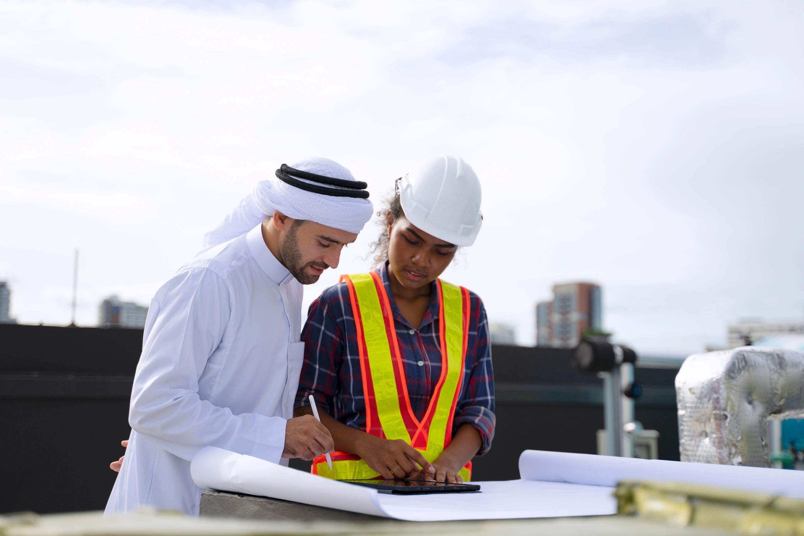 Business representative and engineer reviewing plans at a worksite