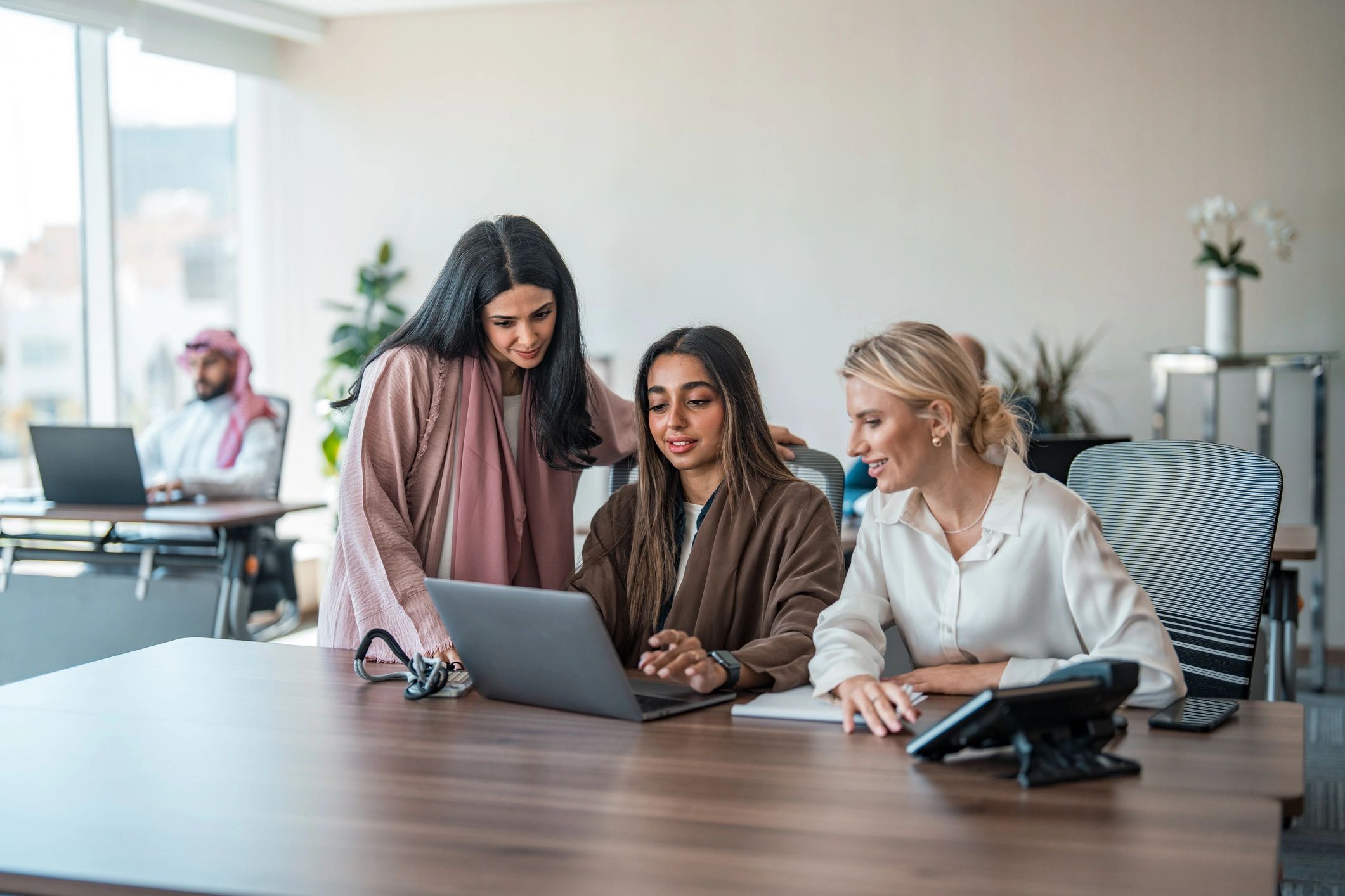 Professionals collaborating at a modern office conference table